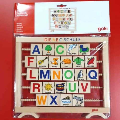 A wooden alphabet learning toy in German language.